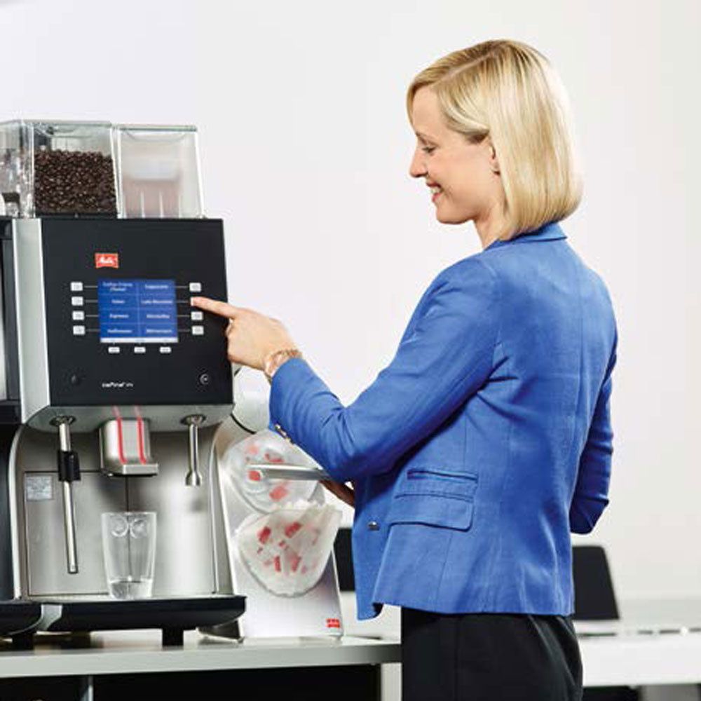 Blonde lady using Melitta XT4 Bean To Cup Coffee Machine
